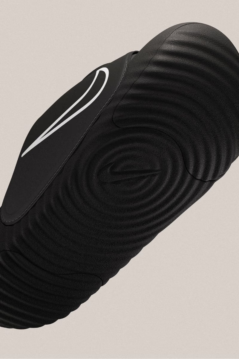 Black Hyperslide sole with embossed Nike swoosh and ribbed texture